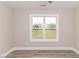 Neutral bedroom featuring hardwood floors, a window with a view of the backyard, and ample space at 117 Knight Rd Rd, Broadway, NC 27505