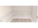 Walk-in closet with wall-mounted wire shelving and gray wood-look flooring at 117 Knight Rd Rd, Broadway, NC 27505
