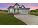 Charming two-story home featuring blue siding, a two-car garage, and a well-manicured lawn at 117 Knight Rd Rd, Broadway, NC 27505