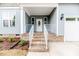 Inviting front porch with brick steps, white railings, and a decorative front door at 117 Knight Rd Rd, Broadway, NC 27505