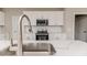 Stylish kitchen showcasing white cabinets, quartz counters, and stainless steel appliances at 117 Knight Rd Rd, Broadway, NC 27505
