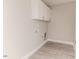 Well-lit laundry area features modern gray floors and white upper cabinets at 117 Knight Rd Rd, Broadway, NC 27505