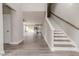 Open-concept living room featuring modern stairs, hardwood flooring, and plenty of natural light at 117 Knight Rd Rd, Broadway, NC 27505