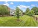 A lush, green backyard shows off a well-maintained lawn, privacy fence, and access to the home's rear deck at 1228 Shakentown St, Knightdale, NC 27545