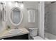 Bathroom featuring modern fixtures, bathtub, and an oval mirror at 1228 Shakentown St, Knightdale, NC 27545