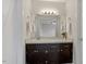 Bathroom vanity featuring dark cabinets and a large mirror at 1228 Shakentown St, Knightdale, NC 27545