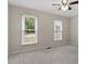 Bright bedroom with neutral carpet and two windows at 1228 Shakentown St, Knightdale, NC 27545