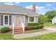 Welcoming front entry with brick steps, tidy landscaping, and covered entrance at 1228 Shakentown St, Knightdale, NC 27545