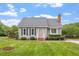 Charming single-story home with manicured lawn and mature landscaping creates a welcoming curb appeal at 1228 Shakentown St, Knightdale, NC 27545