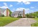 Charming home featuring lush front lawn, driveway, and mature landscaping creates an inviting curb appeal at 1228 Shakentown St, Knightdale, NC 27545