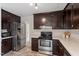 Updated kitchen featuring stainless steel appliances and dark brown cabinets at 1228 Shakentown St, Knightdale, NC 27545