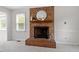Bright living room with neutral carpet and a charming fireplace is ready for cozy evenings at 1228 Shakentown St, Knightdale, NC 27545