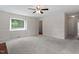 Spacious living room with large window, neutral carpet, and trim provides a serene atmosphere at 1228 Shakentown St, Knightdale, NC 27545
