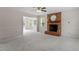 Bright living room features neutral walls, plush carpet, and brick fireplace with hearth and mantle at 1228 Shakentown St, Knightdale, NC 27545