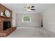 This serene living room boasts neutral walls and carpet with a classic brick fireplace at 1228 Shakentown St, Knightdale, NC 27545