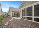 Exterior view of landscaped backyard featuring a patio and sunroom at 125 Greenway Landing Lndg, Chapel Hill, NC 27516