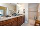 Well-lit bathroom featuring double sinks, granite countertop, and walk-in shower at 125 Greenway Landing Lndg, Chapel Hill, NC 27516
