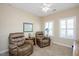 Cozy bedroom with plush seating, neutral walls, plantation shutters, and soft carpet at 125 Greenway Landing Lndg, Chapel Hill, NC 27516