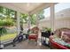 Bright sun room with wicker furniture and views of the landscaped yard at 125 Greenway Landing Lndg, Chapel Hill, NC 27516