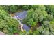 Aerial view of a home with a lush green backyard surrounded by dense trees at 1301 King Cross Ct, Raleigh, NC 27614