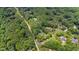 Aerial view showcasing a home with lush trees and neighborhood streets at 1301 King Cross Ct, Raleigh, NC 27614