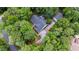 Aerial view of a home with a lush green backyard surrounded by dense trees at 1301 King Cross Ct, Raleigh, NC 27614