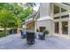 Beautiful home exterior with a spacious deck, outdoor fireplace, and inviting seating, perfect for enjoying the serene backyard at 1301 King Cross Ct, Raleigh, NC 27614
