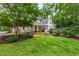 Beautifully landscaped backyard featuring a well-maintained lawn and multiple outdoor living spaces, perfect for entertaining at 1301 King Cross Ct, Raleigh, NC 27614