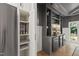 The custom bar boasts a beverage cooler, built-in shelves and ambient lighting for a cozy atmosphere at 1301 King Cross Ct, Raleigh, NC 27614