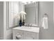 Bathroom vanity with marble countertop, decorative mirror, and blue accents at 1301 King Cross Ct, Raleigh, NC 27614