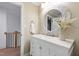 Elegant bathroom vanity with decorative mirror and a staircase in the background at 1301 King Cross Ct, Raleigh, NC 27614