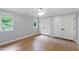 Bright bedroom featuring hardwood floors, a ceiling fan, and double door closets at 1301 King Cross Ct, Raleigh, NC 27614