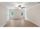 Bedroom features hardwood floors, a ceiling fan, two windows, and a closet at 1301 King Cross Ct, Raleigh, NC 27614