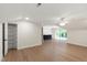 Bright bonus room featuring hardwood floors, a ceiling fan, walk-in closet, and a wet bar near a large window at 1301 King Cross Ct, Raleigh, NC 27614