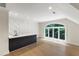 Large bonus room with a wet bar, hardwood floors, and a large arched window at 1301 King Cross Ct, Raleigh, NC 27614
