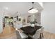 Bright dining area showcasing a modern pendant light and open access to the stylish kitchen and living spaces at 1301 King Cross Ct, Raleigh, NC 27614