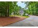 Inviting home with attached garage, long driveway, and well-maintained lawn in a picturesque, wooded area at 1301 King Cross Ct, Raleigh, NC 27614