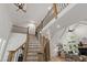 Grand foyer with a staircase, wooden banisters, and views into the living room at 1301 King Cross Ct, Raleigh, NC 27614