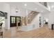 Spacious foyer with hardwood floors, modern staircase, and seamless flow into other living areas at 1301 King Cross Ct, Raleigh, NC 27614