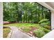 Expansive front yard featuring professionally landscaped garden beds and mature trees at 1301 King Cross Ct, Raleigh, NC 27614