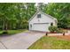 Exterior view of the white brick garage with a concrete driveway and manicured landscaping at 1301 King Cross Ct, Raleigh, NC 27614