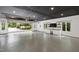 Modern garage with gray floors, white cabinets, drink fridge and a television screen at 1301 King Cross Ct, Raleigh, NC 27614