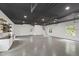 Spacious garage with white walls, epoxy floors, storage shelves, and a stylish dark ceiling at 1301 King Cross Ct, Raleigh, NC 27614