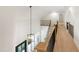 Hallway features hardwood floors, stairs with black railing, wainscoting accent wall, and a hanging light fixture at 1301 King Cross Ct, Raleigh, NC 27614