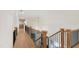 Hallway with hardwood floors and a black railing overlooks the lower level at 1301 King Cross Ct, Raleigh, NC 27614