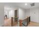 Upstairs hallway with oak railing, hardwood floors, and white walls and trim at 1301 King Cross Ct, Raleigh, NC 27614