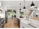 Spacious kitchen featuring a center island, stainless steel appliances, and a seamless transition to the living area at 1301 King Cross Ct, Raleigh, NC 27614