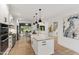 Bright, updated kitchen features an island, stainless appliances, and open access to the breakfast and living areas at 1301 King Cross Ct, Raleigh, NC 27614