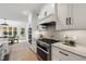 Well-equipped kitchen with modern appliances, white cabinetry, granite countertops, and seamless access to the breakfast area at 1301 King Cross Ct, Raleigh, NC 27614