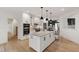Modern kitchen features white cabinets, a large island, stainless steel appliances, and sleek black pendant lights at 1301 King Cross Ct, Raleigh, NC 27614